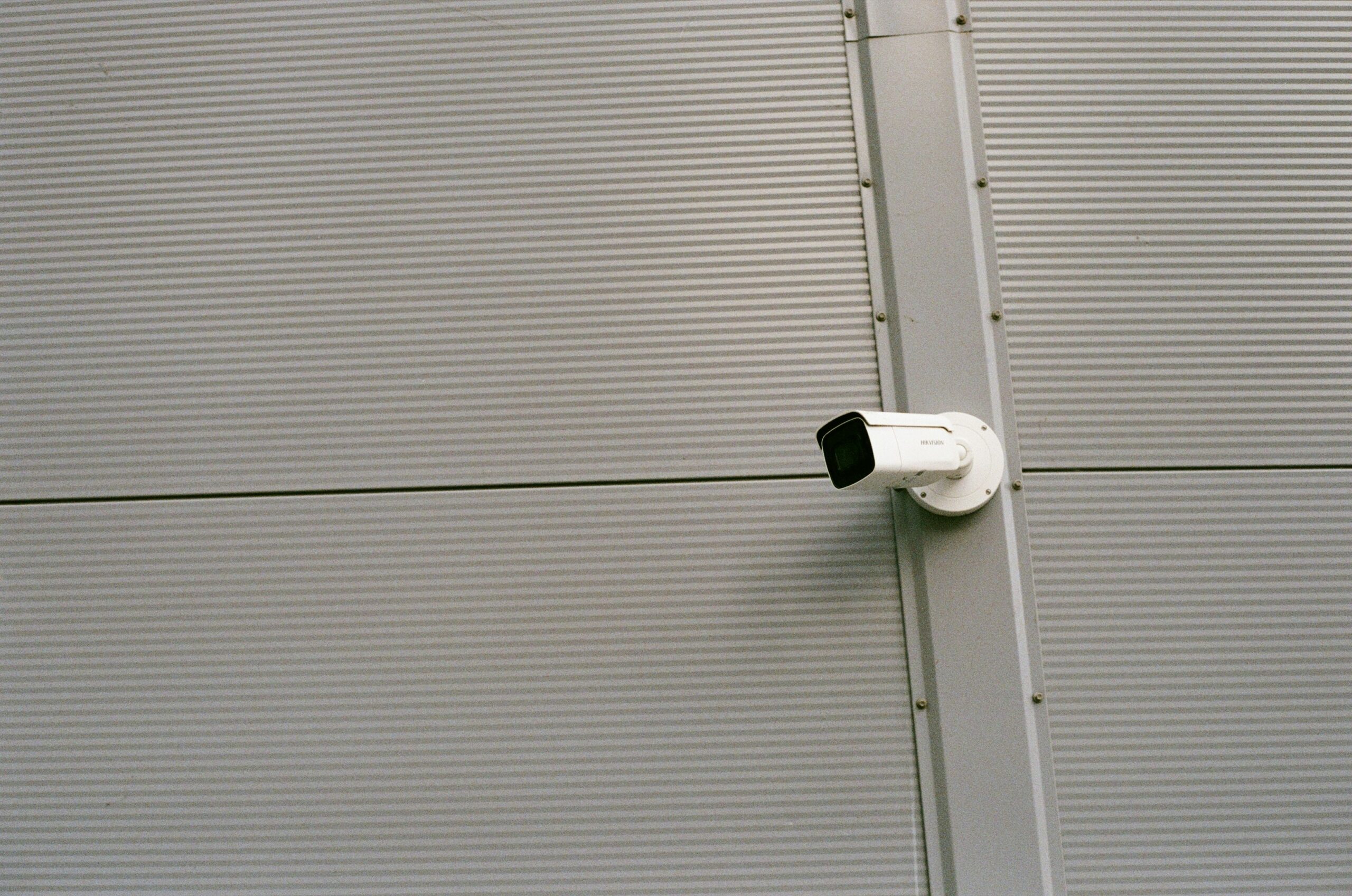 A homeowner installing security cameras to prevent vandalism