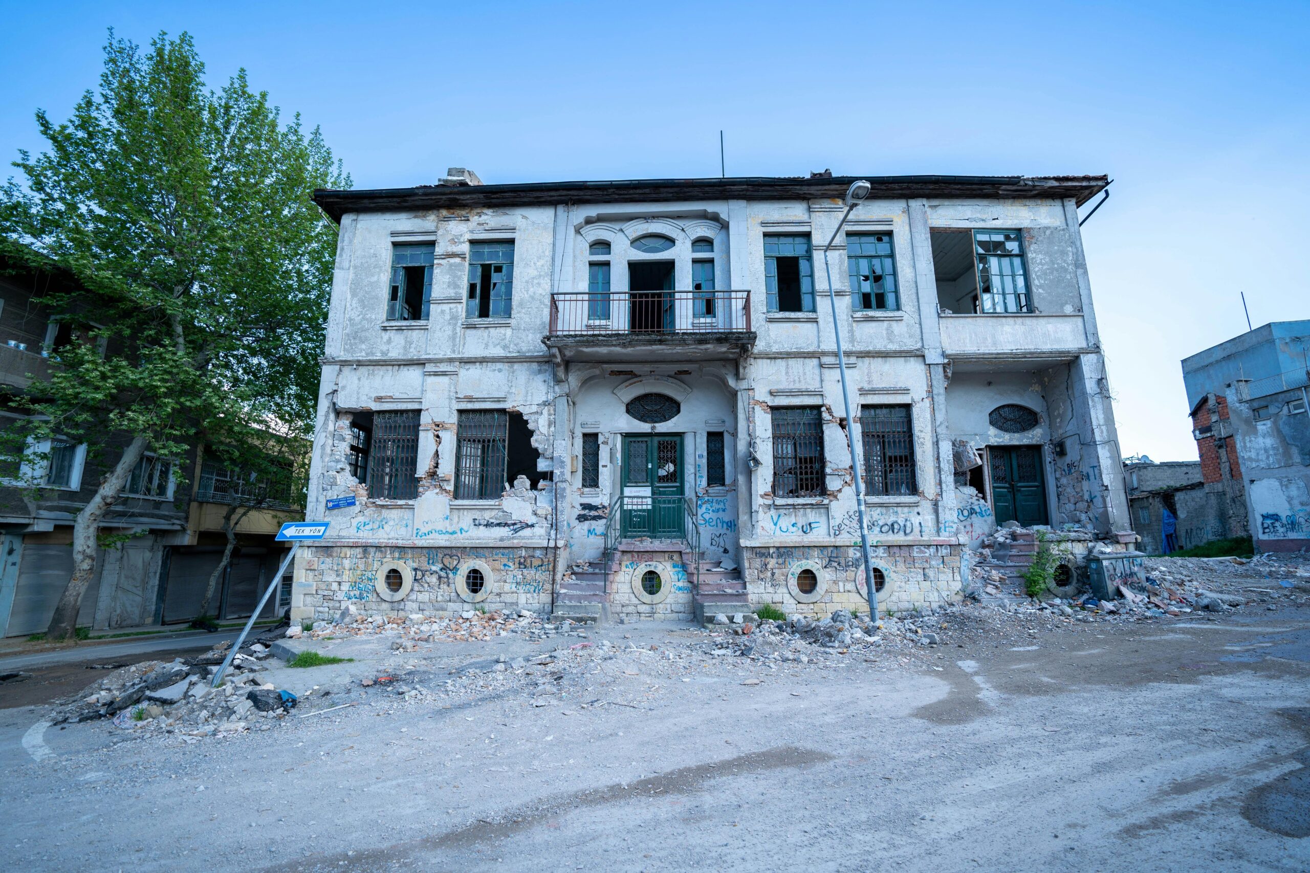 Damaged property due to vandalism including graffiti and broken windows