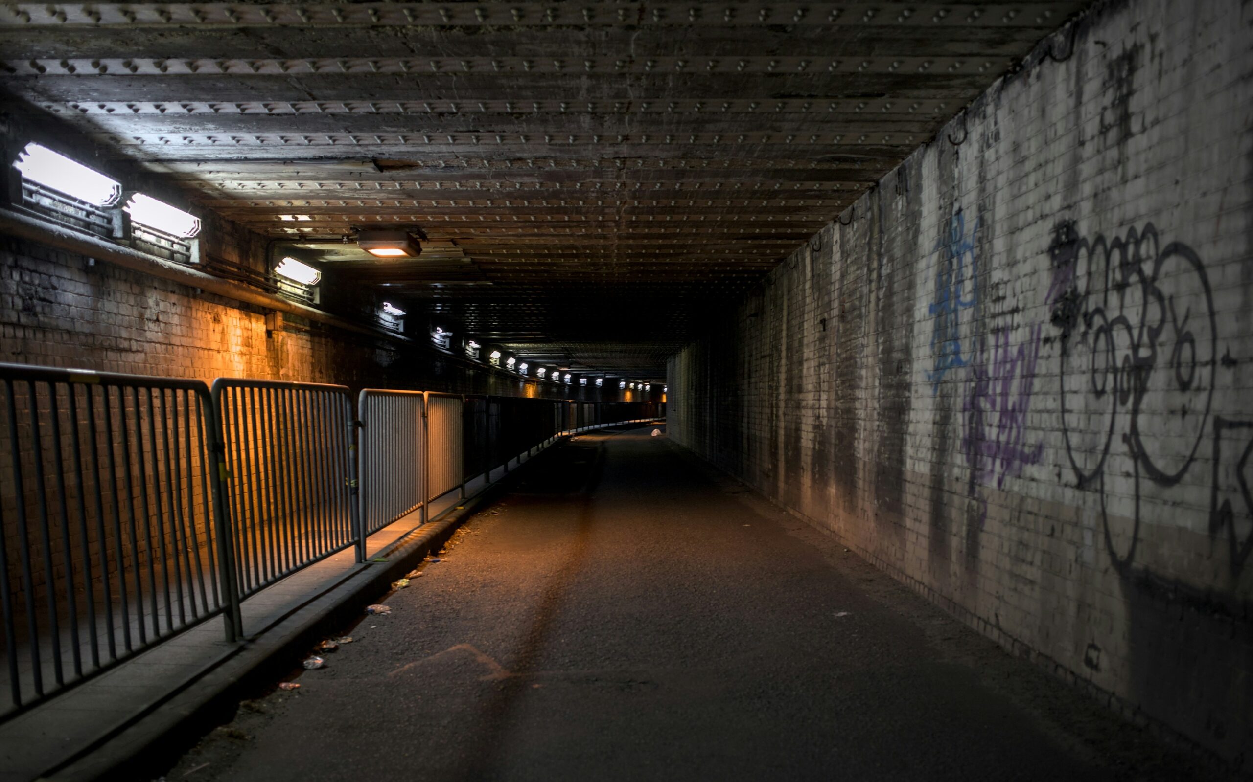 Dark alleyway illustrating poor visibility leading to potential vandalism