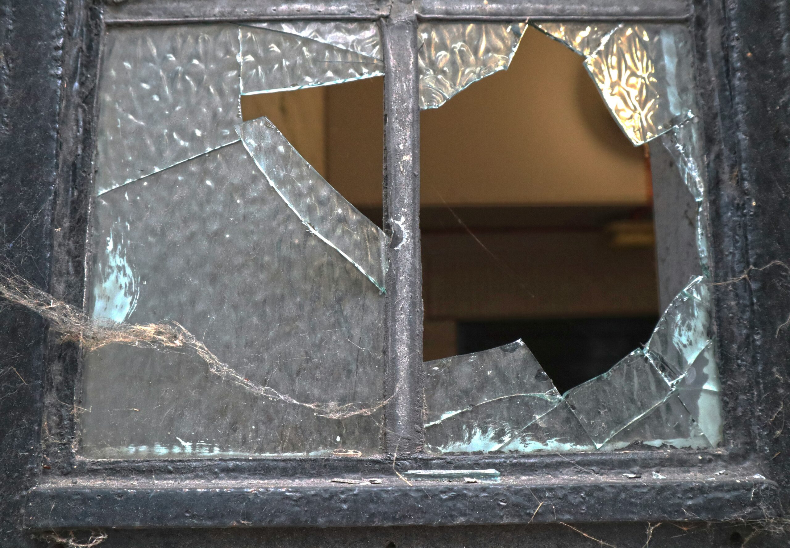 A damaged garage door illustrating potential repair costs from vandalism