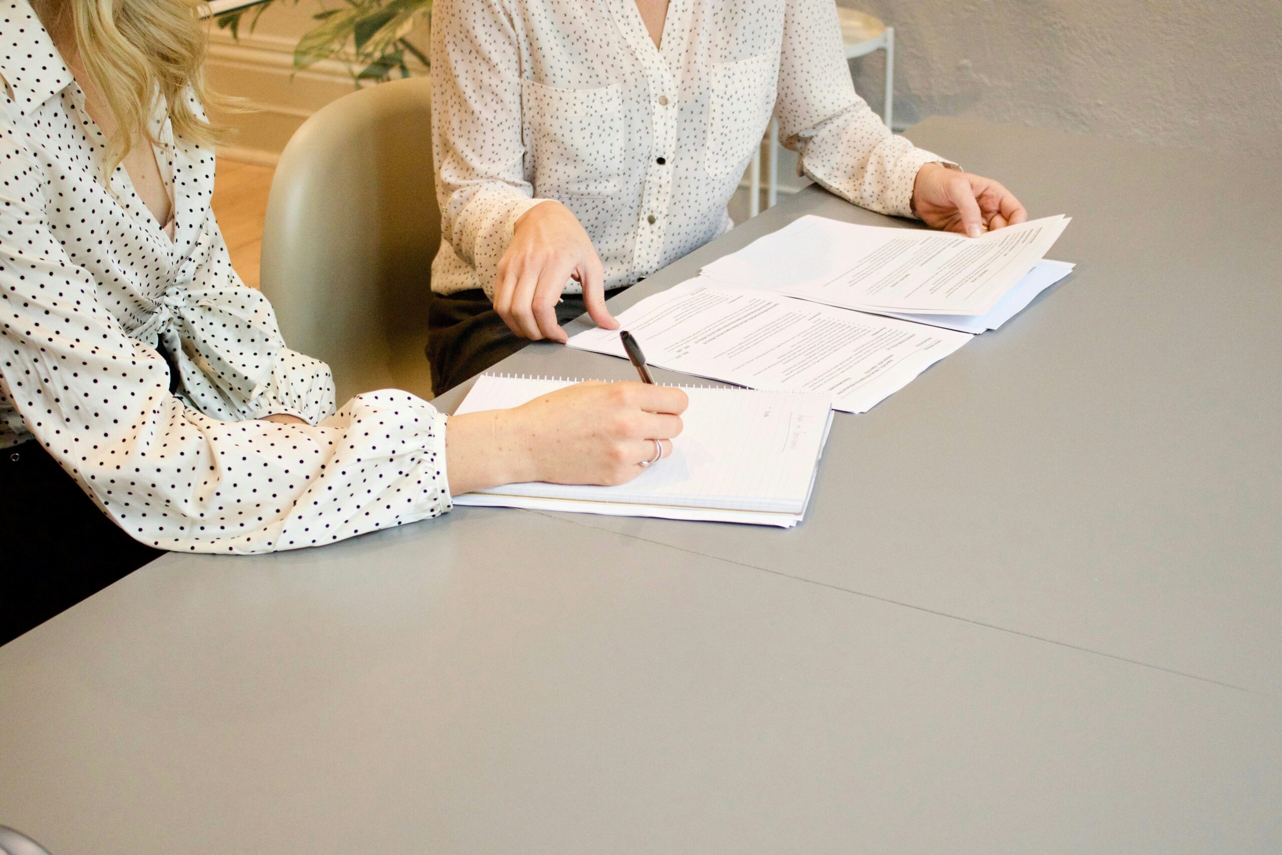 Close-up of insurance documents spread across a desk with a pen highlighting key sections.