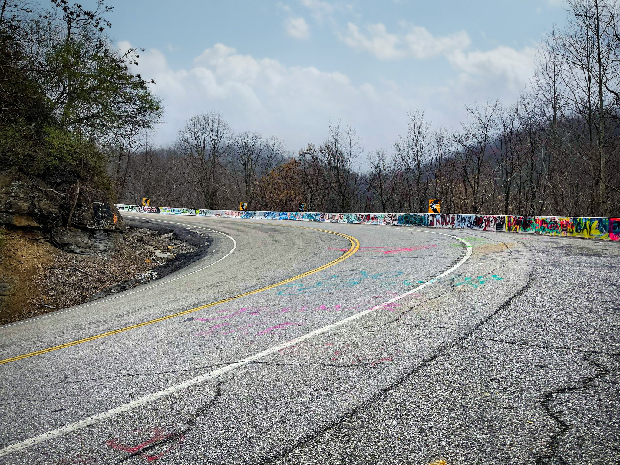 Man installing a security camera outside a house.