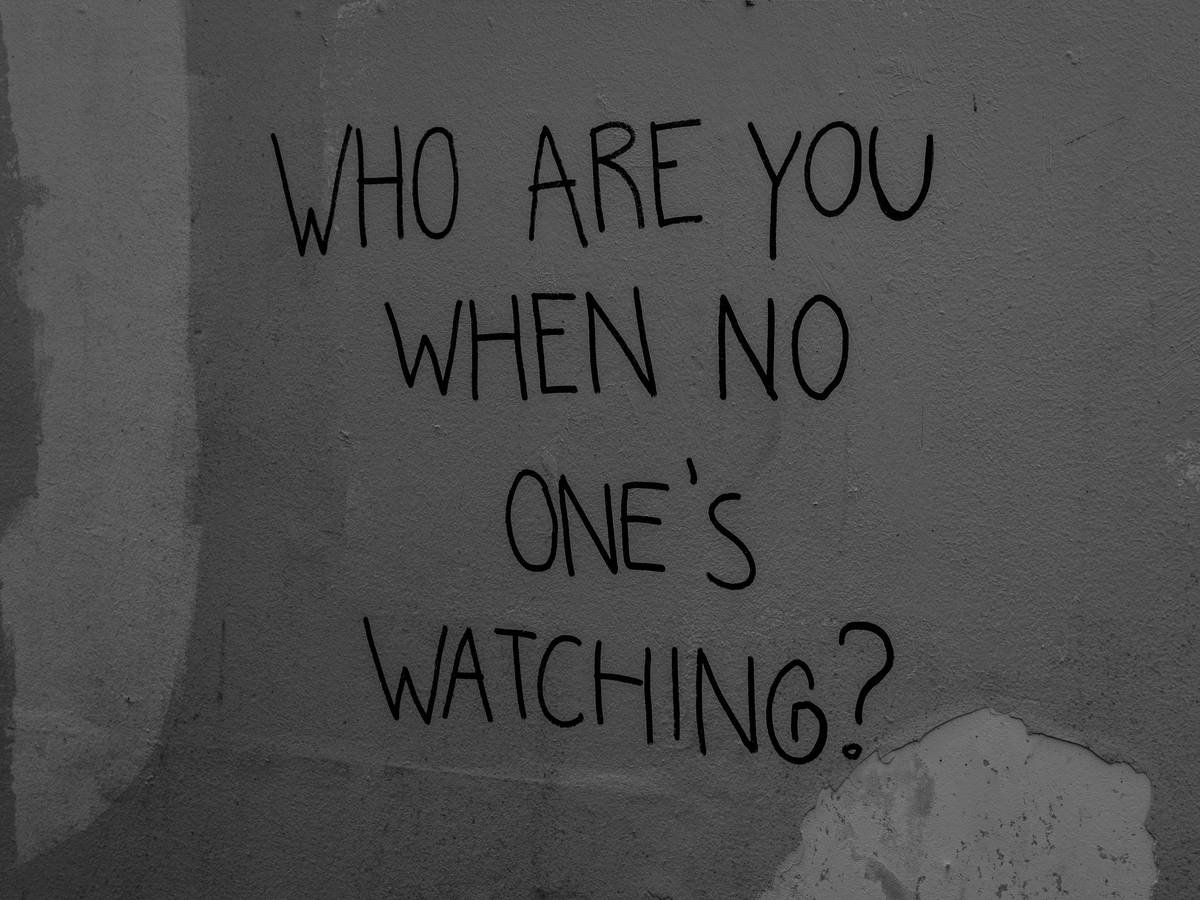 Mural with a written text 'who are you when no one's watching?" on it..