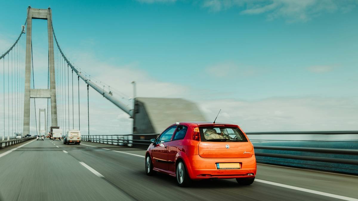 Red Fiat Punto Car on The Great Belt Bridge in Denmark